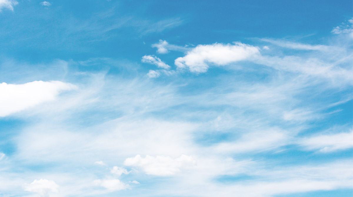 Blue sky with soft white clouds spread across the horizon.